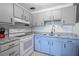 Well-lit kitchen featuring updated cabinets, granite countertops, and modern appliances at 8325 112Th St # 202, Seminole, FL 33772