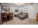 Living room featuring a couch, tv, bar and seating, and neutral carpeting at 8325 112Th St # 202, Seminole, FL 33772