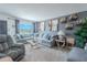 Comfortable living room featuring a large sofa, art decor, and bright natural lighting at 8325 112Th St # 202, Seminole, FL 33772