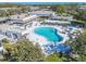 Aerial view showcasing the large community pool with lounge seating and umbrellas at 8325 112Th St # 202, Seminole, FL 33772