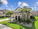 Well-manicured lawn and landscaping accentuate this home's beautiful exterior stone accents at 8837 Garden Party Dr, Land O Lakes, FL 34637