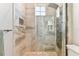 Elegant glass shower with brushed metal fixtures and a convenient built in shower seat at 8837 Garden Party Dr, Land O Lakes, FL 34637