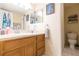 Bathroom with light wood vanity, framed mirrors, and a separate toilet area at 9100 Dr Martin Luther King Jr N St # 405, St Petersburg, FL 33702