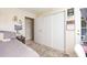 Comfortable bedroom featuring a sliding closet with a patterned rug and cozy bed at 9100 Dr Martin Luther King Jr N St # 405, St Petersburg, FL 33702