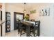 Dining area with seating for four, modern light fixture, and decorative mirror at 9100 Dr Martin Luther King Jr N St # 405, St Petersburg, FL 33702