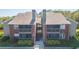 Brick exterior of two-story condo with screened balconies and manicured landscaping in a waterfront community at 9100 Dr Martin Luther King Jr N St # 405, St Petersburg, FL 33702