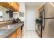 Kitchen area featuring stainless steel appliances, light wood cabinets, and tile flooring at 9100 Dr Martin Luther King Jr N St # 405, St Petersburg, FL 33702