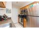 Kitchen area featuring stainless steel appliances, light wood cabinets, and tile flooring at 9100 Dr Martin Luther King Jr N St # 405, St Petersburg, FL 33702