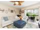 Bright living room with comfortable seating and sliding doors to the balcony overlooking nature in a waterfront condo at 9100 Dr Martin Luther King Jr N St # 405, St Petersburg, FL 33702