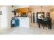 Open-concept kitchen and dining area with tiled flooring and a bar counter perfect for entertaining at 9100 Dr Martin Luther King Jr N St # 405, St Petersburg, FL 33702