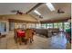 Spacious lounge area with skylights, ceiling fans, multiple sofas, and a dining table with seating for a comfortable space at 9100 Dr Martin Luther King Jr N St # 405, St Petersburg, FL 33702