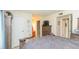 Spacious bedroom with wood furniture, ensuite bathroom, and neutral walls at 9100 Dr Martin Luther King Jr N St # 405, St Petersburg, FL 33702