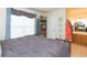 Bedroom with a rustic wood bed, large window with curtains, and a view of the ensuite bathroom at 9100 Dr Martin Luther King Jr N St # 405, St Petersburg, FL 33702