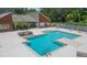 A stunning view of the large, sparkling pool and lounge area with a red brick recreation building at 9100 Dr Martin Luther King Jr N St # 405, St Petersburg, FL 33702