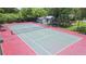 A full view of the fenced tennis court surrounded by trees and greenery at 9100 Dr Martin Luther King Jr N St # 405, St Petersburg, FL 33702
