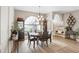 Dining room featuring hardwood floors, chandelier and arched window which brings in natural light at 10014 Vista Pointe Dr, Tampa, FL 33635