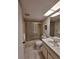 Well-lit bathroom with a shower-tub, vanity, and decorative floral wallpaper at 1010 Bowsprit Ln # 0, Holiday, FL 34691
