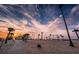 Scenic beach with sandy volleyball court, palm trees, and a vibrant sunset at 1010 Bowsprit Ln # 0, Holiday, FL 34691