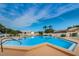 Community pool with plenty of space for swimming and lounging under the sunny, blue sky at 1010 Bowsprit Ln # 0, Holiday, FL 34691