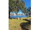 Scenic water view with two chairs, trees, and a fountain, creating a tranquil outdoor setting at 1010 Bowsprit Ln # 0, Holiday, FL 34691