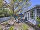 Backyard featuring a mature tree, seating, and view of the house at 10128 114Th N Ter, Largo, FL 33773