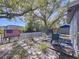 Backyard featuring a deck, a white picket fence, and a mature tree at 10128 114Th N Ter, Largo, FL 33773