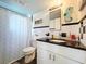 Bathroom featuring a shower with curtain, a vanity sink, and decorative seahorse on the wall at 10128 114Th N Ter, Largo, FL 33773