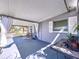 Inviting front porch featuring comfortable seating, stylish decor, and covered space at 10128 114Th N Ter, Largo, FL 33773