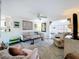 Bright living room features a ceiling fan, neutral color palette, and doorways to other rooms at 10128 114Th N Ter, Largo, FL 33773