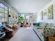 Bright sunroom adorned with plants and a floral sofa; perfect for relaxation at 10128 114Th N Ter, Largo, FL 33773