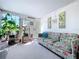 This inviting sunroom boasts great natural light, plants, and a cozy floral sofa at 10128 114Th N Ter, Largo, FL 33773