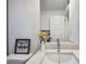 Well-lit bathroom featuring a white vanity with a granite countertop and a framed mirror at 10847 Bounty St, New Port Richey, FL 34654