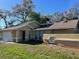 Inviting home featuring a well-manicured lawn and an attached two-car garage at 11059 Maderia St, Spring Hill, FL 34608