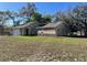 Inviting home featuring a well-manicured lawn and an attached two-car garage at 11059 Maderia St, Spring Hill, FL 34608