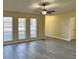 A view of the modern living room with multiple large windows and sleek flooring at 11059 Maderia St, Spring Hill, FL 34608