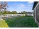 Spacious, fenced backyard with green grass and a trampoline at 11432 Leland Groves Dr, Riverview, FL 33579