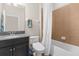 This bathroom has a single sink vanity with granite counters and a tub and shower combo at 11432 Leland Groves Dr, Riverview, FL 33579