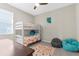 Charming bedroom with bunk beds, a window, and comfortable-looking beanbag chairs at 11432 Leland Groves Dr, Riverview, FL 33579