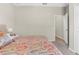 View of bedroom showcasing the neutral paint, carpet, and a doorway, with a colorful patterned bed in the foreground at 11432 Leland Groves Dr, Riverview, FL 33579