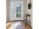 Inviting entryway with decorative glass door, stylish table, and rustic wall décor at 11432 Leland Groves Dr, Riverview, FL 33579