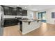 Modern kitchen features dark cabinets, granite countertops, stainless steel appliances, and an island at 11432 Leland Groves Dr, Riverview, FL 33579
