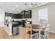Open kitchen and dining area with dark cabinets, granite counters and stainless appliances at 11432 Leland Groves Dr, Riverview, FL 33579