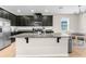 Bright kitchen featuring dark cabinets, granite countertops, and stainless steel appliances at 11432 Leland Groves Dr, Riverview, FL 33579