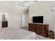 The spacious main bedroom includes a large dresser and entry into the bathroom at 11432 Leland Groves Dr, Riverview, FL 33579