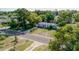 An aerial shot of a light grey single-story house with a wide front yard and an expansive green lawn at 1211 E Camellia Dr., Brandon, FL 33510