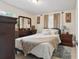 Cozy bedroom with warm tones, featuring a comfortable bed and dark wood furniture at 1211 E Camellia Dr., Brandon, FL 33510
