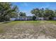 Charming single-story home featuring a well-maintained lawn, mature trees, and a welcoming facade under a clear blue sky at 1211 E Camellia Dr., Brandon, FL 33510
