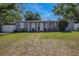 The home boasts a well-kept lawn, tidy landscaping, and a welcoming facade, set against a clear, sunny sky at 1211 E Camellia Dr., Brandon, FL 33510