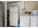 Functional laundry area featuring a washer, dryer, and water heater for household convenience at 1211 E Camellia Dr., Brandon, FL 33510
