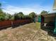 Spacious backyard featuring privacy fence, shed, and screened patio for outdoor activities at 1223 Union St, Clearwater, FL 33755